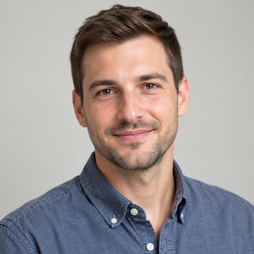 Portrait of a young man with short hair and a friendly expression