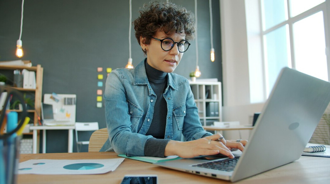 person working on laptop in modern office